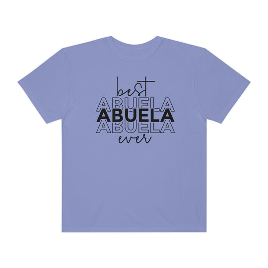 A ring-spun cotton Best Abuela Ever Tee in purple with black text. Garment-dyed for extra coziness, featuring a relaxed fit, double-needle stitching, and no side-seams for durability and shape retention.