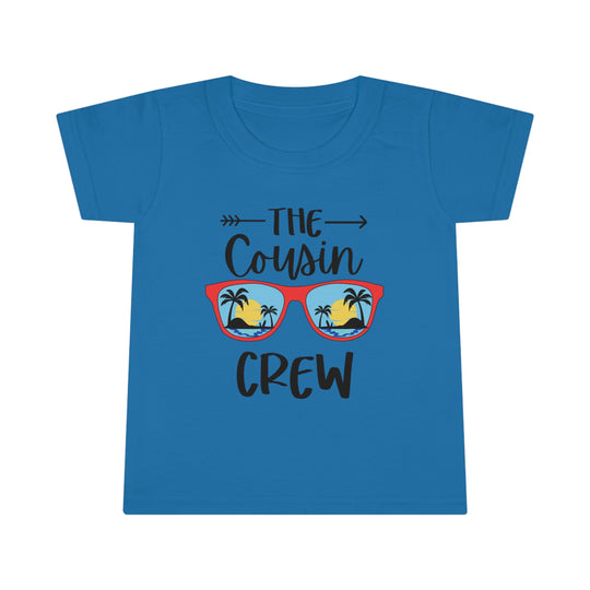 Toddler tee featuring Cousin Crew design on blue shirt with sunglasses-wearing person, beach, palm trees. Classic fit, high stitch density, double-needle collar, sleeve, bottom hems for durability. Ideal for kids.