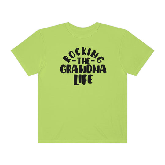 Rocking the Grandma Life Tee: A green shirt with black text, 100% ring-spun cotton, medium weight, relaxed fit, durable double-needle stitching, tubular shape. Ideal for daily wear.