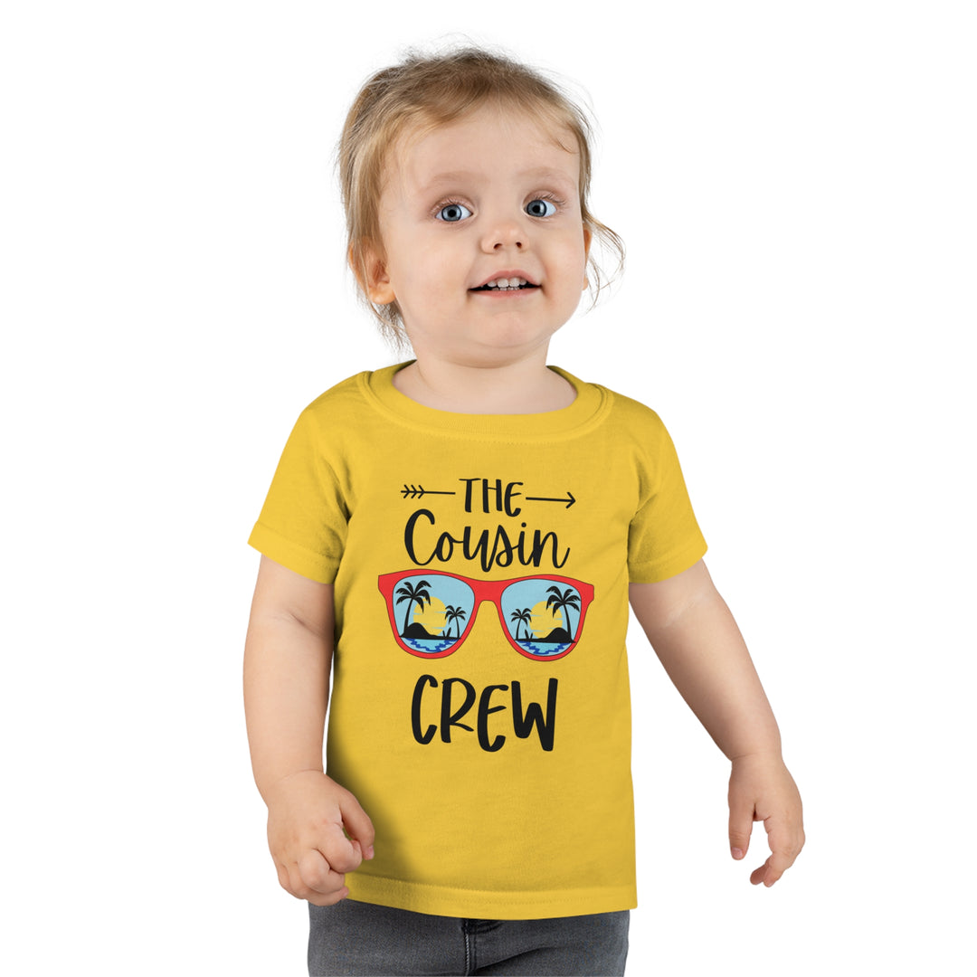 A personalized Cousin Crew Toddler Tee by Gildan 64500P, featuring a child in a yellow shirt. Classic fit, 100% Ringspun cotton, 3/4 double-needle collar, and durable double-needle hems. Ideal for comfy and stylish wear.