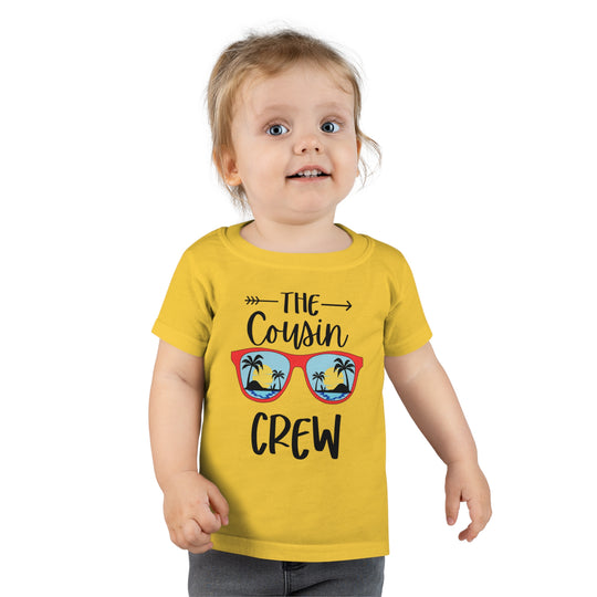 A personalized Cousin Crew Toddler Tee by Gildan 64500P, featuring a child in a yellow shirt. Classic fit, 100% Ringspun cotton, 3/4 double-needle collar, and durable double-needle hems. Ideal for comfy and stylish wear.