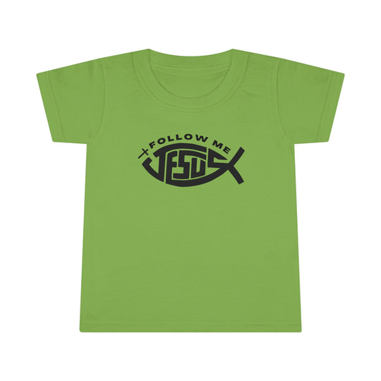 A Jesus Follow Me Toddler Tee with a green shirt featuring a black design. Classic fit, 100% Ringspun cotton, durable double-needle stitching, and 3/4 collar. Ideal for active kids.