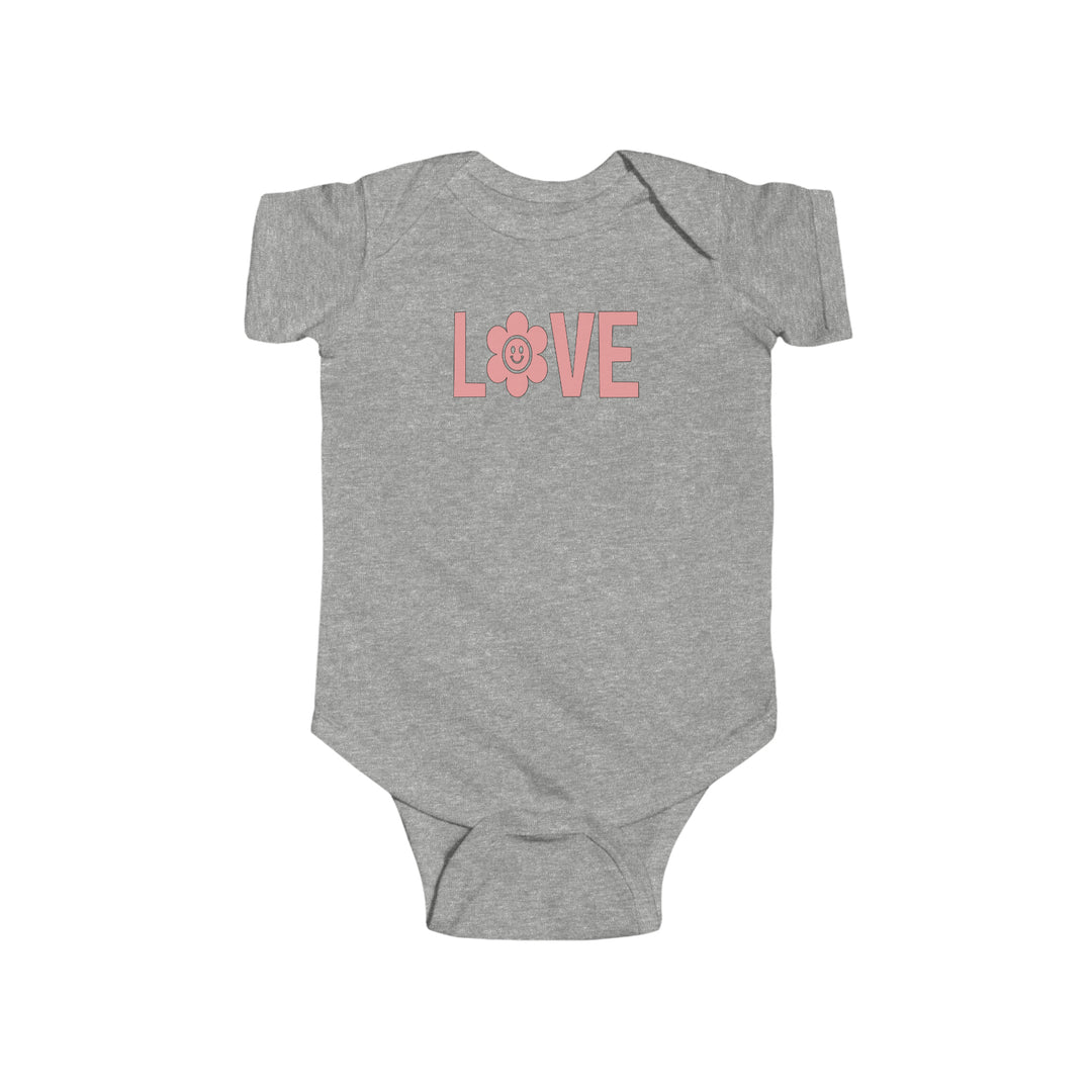 A grey baby bodysuit featuring pink text and a pink flower design, perfect for infants. Made of 100% cotton, with ribbed knitting for durability and easy snap closure. From Worlds Worst Tees' Love Onesie collection.
