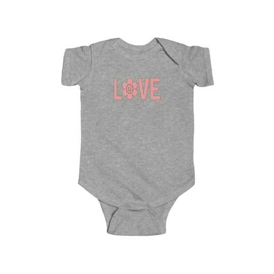 A grey baby bodysuit featuring pink text and a pink flower design, perfect for infants. Made of 100% cotton, with ribbed knitting for durability and easy snap closure. From Worlds Worst Tees' Love Onesie collection.