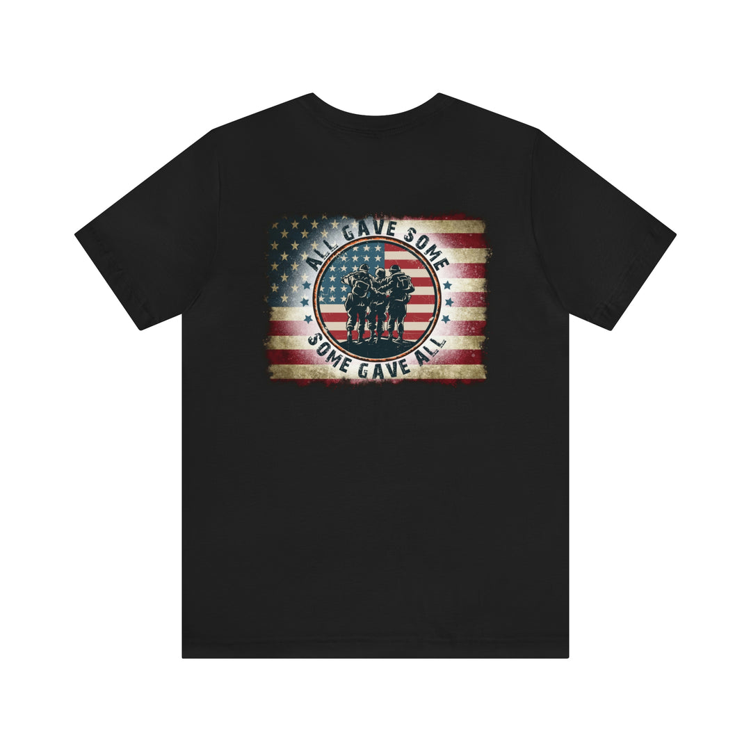 Black tee featuring a flag and soldiers, part of the USA Some Gave All Tee collection. Unisex fit, 100% cotton, with ribbed knit collars and taping for durability.