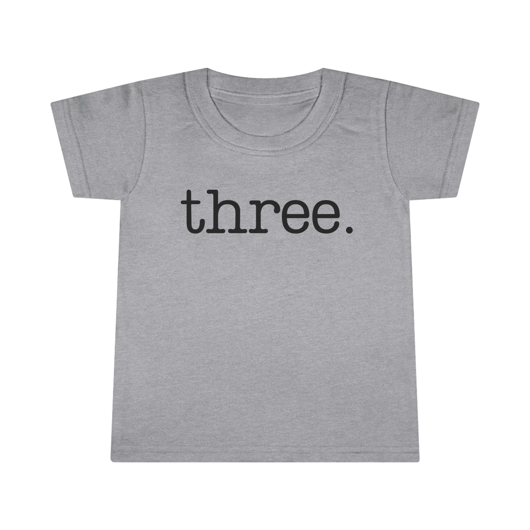 A durable Three Toddler Tee in classic fit, featuring high stitch density and double-needle topstitched collar. Made of 100% Ringspun cotton, light fabric. From 'Worlds Worst Tees'.