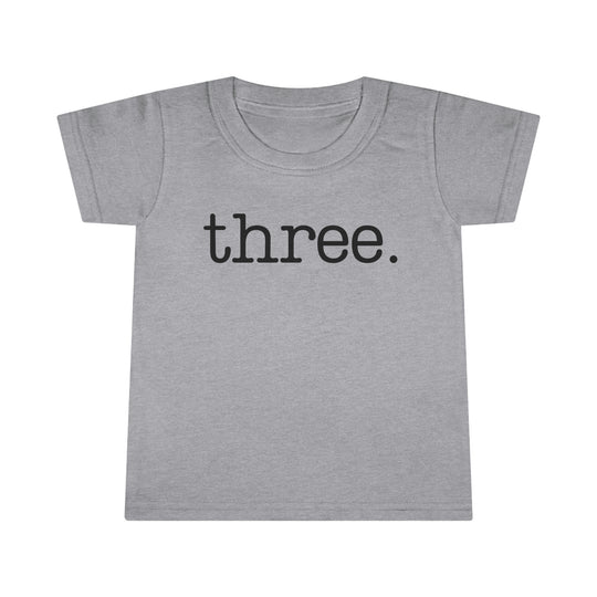 A durable Three Toddler Tee in classic fit, featuring high stitch density and double-needle topstitched collar. Made of 100% Ringspun cotton, light fabric. From 'Worlds Worst Tees'.