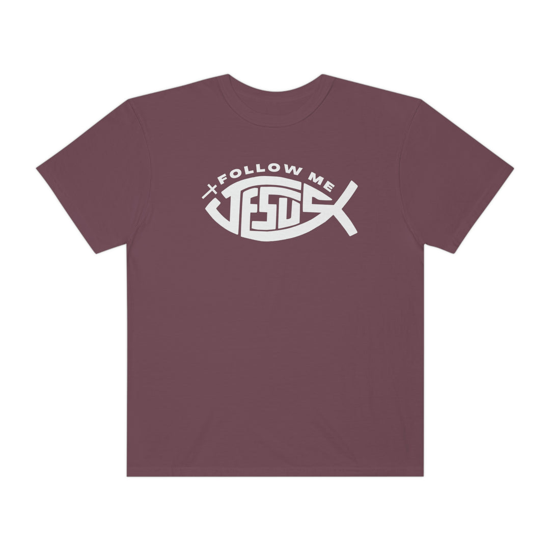 Relaxed fit Jesus Follow Me Tee, purple with fish design. 100% ring-spun cotton, garment-dyed for coziness. Durable double-needle stitching, no side-seams for a tubular shape.