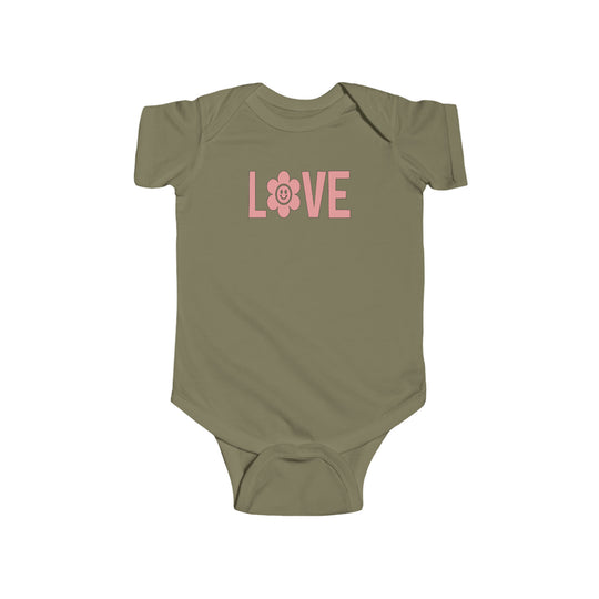A green baby bodysuit featuring a pink logo and flower, ideal for infants. Made of 100% cotton, with ribbed knitting for durability and plastic snaps for easy changing. Love Onesie by Worlds Worst Tees.