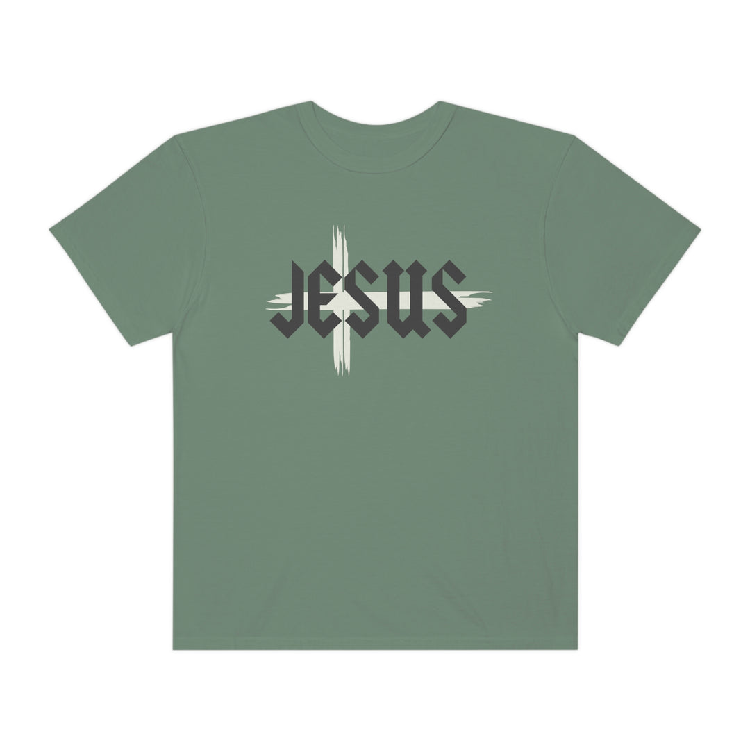 A Jesus Tee, a green t-shirt with a cross logo, made of 100% ring-spun cotton. Garment-dyed for extra coziness, with a relaxed fit and durable double-needle stitching. From Worlds Worst Tees.