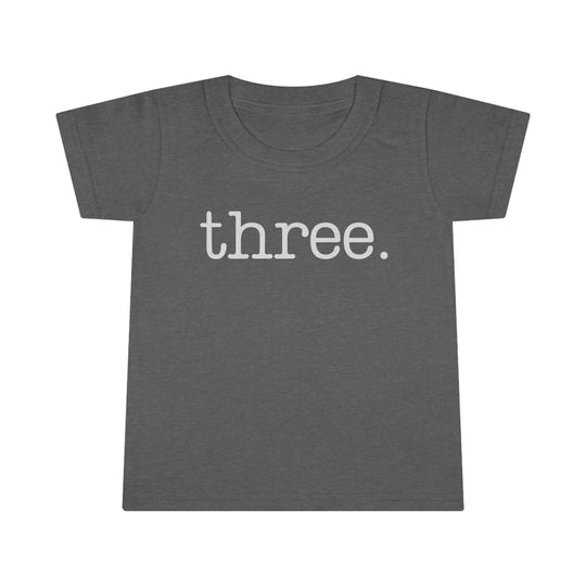 A durable Three Toddler Tee in grey with white text from Worlds Worst Tees. Classic fit, high stitch density, double-needle collar, sleeves, and hems. Made of 100% Ringspun cotton, light fabric.