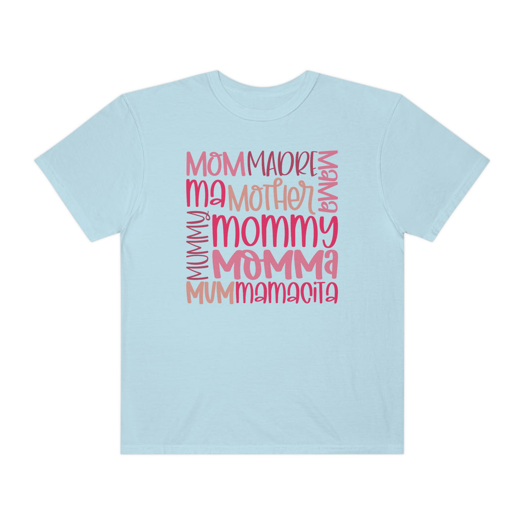 A Mama Tee in light blue with pink text, made of 100% ring-spun cotton. Garment-dyed for extra coziness, featuring a relaxed fit, double-needle stitching, and no side-seams for durability and shape retention.