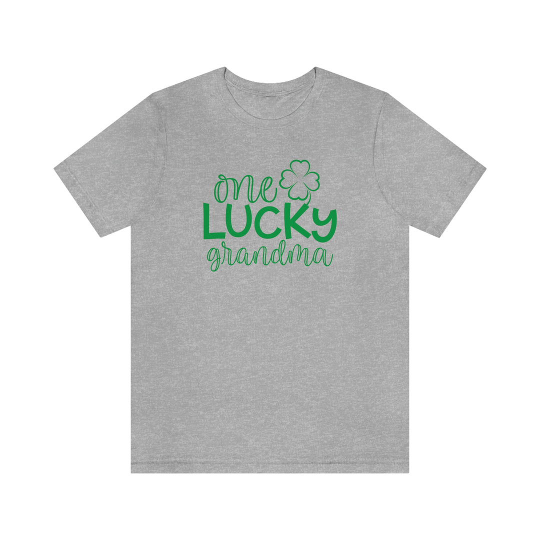 A classic unisex jersey tee featuring One Lucky Grandma text. Soft cotton, ribbed knit collars, and shoulder taping for durability. Retail fit, 100% cotton, light fabric. Sizes XS to 3XL.