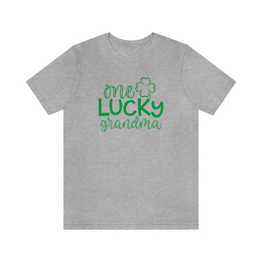 A classic unisex jersey tee featuring One Lucky Grandma text. Soft cotton, ribbed knit collars, and shoulder taping for durability. Retail fit, 100% cotton, light fabric. Sizes XS to 3XL.