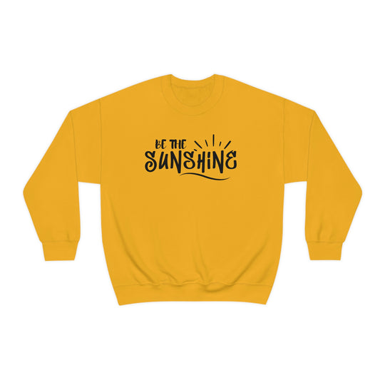 A unisex heavy blend crewneck sweatshirt, Be The Sunshine Crewneck, in yellow with black text. Made of 50% cotton, 50% polyester, medium-heavy fabric, loose fit, ribbed knit collar, no itchy side seams. Sewn-in label, true to size.