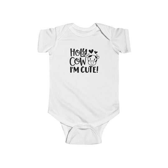 A white baby bodysuit with black text, featuring the product title Holy Cow I'm Cute Onesie from Worlds Worst Tees. Made of 100% cotton, durable seams, ribbed bindings, and plastic snaps for easy changing.