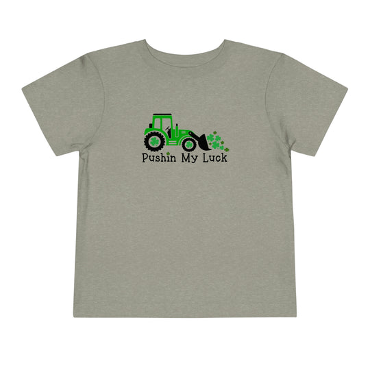 Toddler tee featuring a tractor design, perfect for everyday wear. Made of 100% Airlume combed and ring-spun cotton, with short sleeves and tear-away label for comfort. Customize in various sizes.