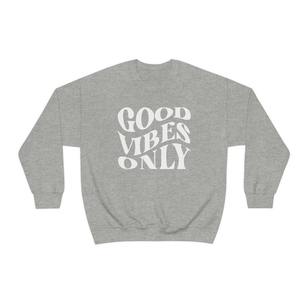 A grey crewneck sweatshirt with Good Vibes Only text. Unisex heavy blend, 50% cotton, 50% polyester, loose fit, ribbed knit collar, no itchy side seams. Sizes S-5XL. Sewn-in label.