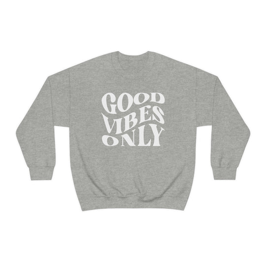 A grey crewneck sweatshirt with Good Vibes Only text. Unisex heavy blend, 50% cotton, 50% polyester, loose fit, ribbed knit collar, no itchy side seams. Sizes S-5XL. Sewn-in label.