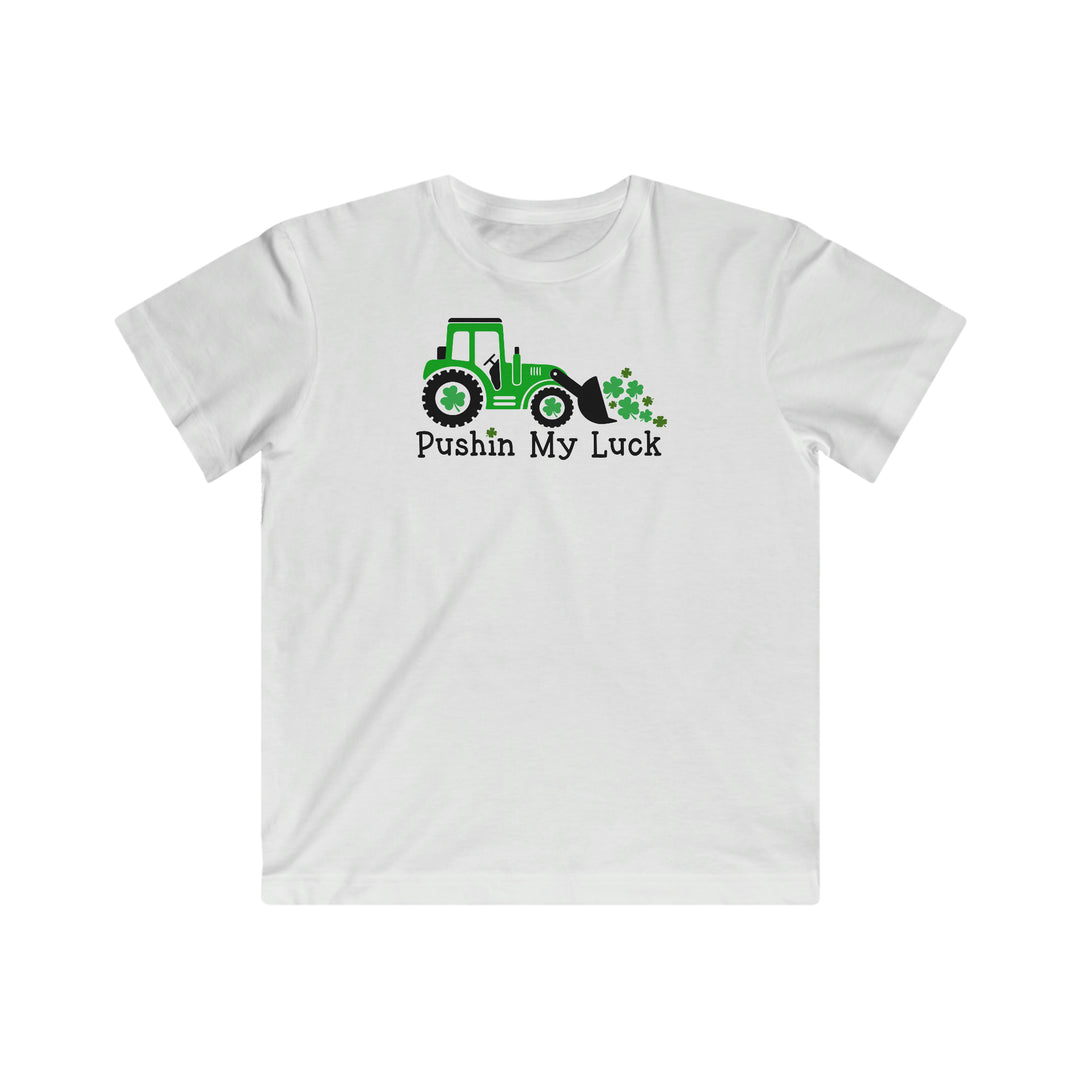 Pushin My Luck Kids Tee: White t-shirt featuring a tractor, clovers, and playful text. Soft, high-quality cotton, regular fit, ideal for kids. Sizes XS to XL. From Worlds Worst Tees.