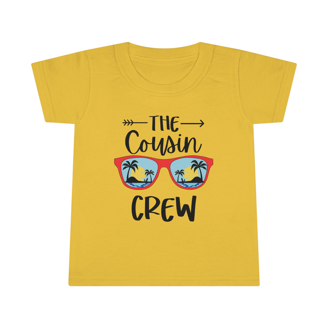 A Cousin Crew Toddler Tee with a graphic of sunglasses and palm trees on a yellow shirt. Features a classic fit, high stitch density, and double-needle collar and hems for durability. Made of 100% Ringspun cotton.