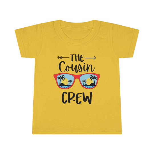 A Cousin Crew Toddler Tee with a graphic of sunglasses and palm trees on a yellow shirt. Features a classic fit, high stitch density, and double-needle collar and hems for durability. Made of 100% Ringspun cotton.