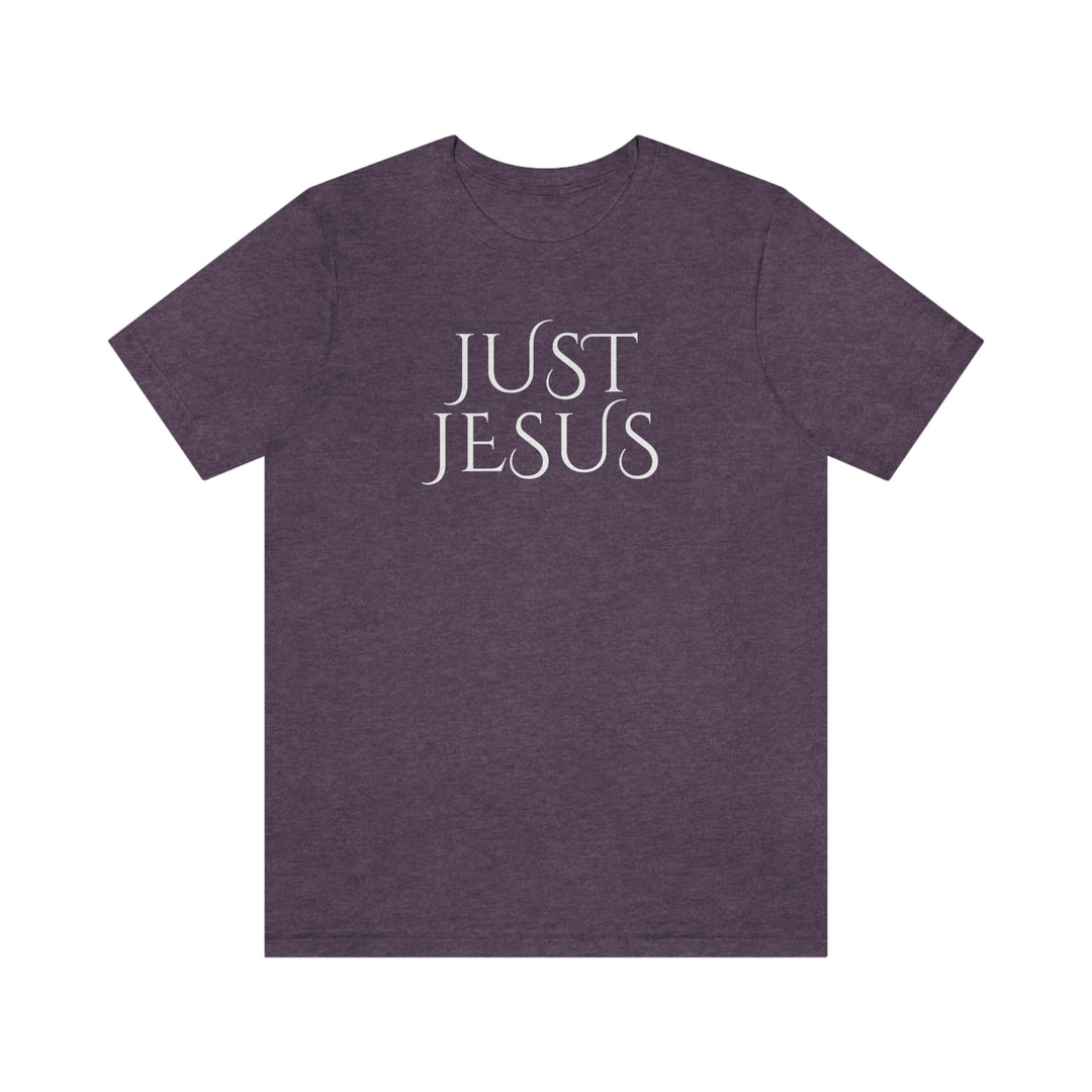 Unisex Just Jesus Tee: Purple shirt with white text, featuring ribbed knit collars, taping on shoulders for fit, and side seams for shape retention. Made of 100% Airlume combed cotton. Sizes XS-3XL.