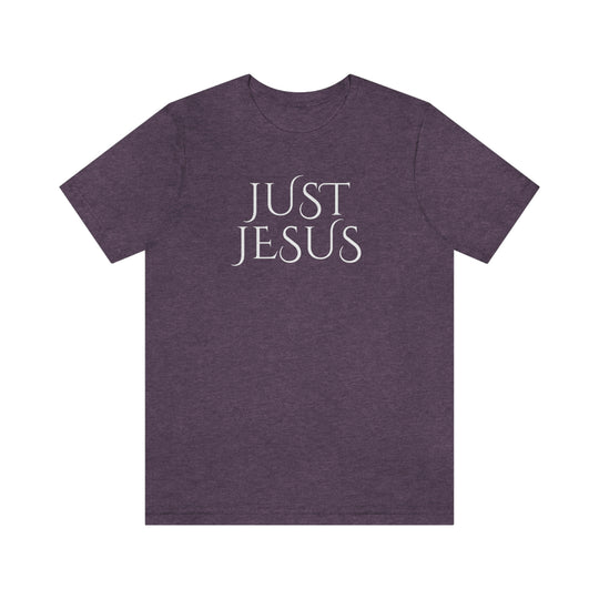 Unisex Just Jesus Tee: Purple shirt with white text, featuring ribbed knit collars, taping on shoulders for fit, and side seams for shape retention. Made of 100% Airlume combed cotton. Sizes XS-3XL.